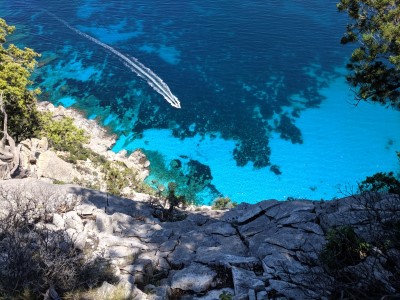Cala Biriala, Sardinia, Italy - A rowboat from the cliffs above on my hike to Cala Biriala on our trip to Sardinia in 2019